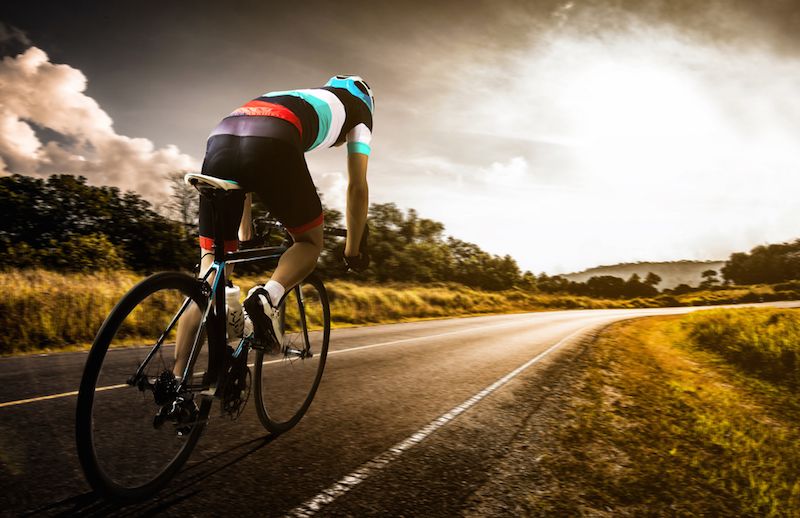 A cyclist rides his bike.