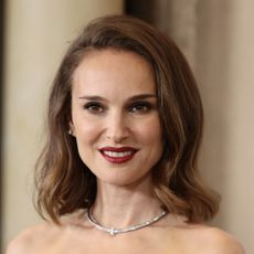 Natalie Portman wearing bold lipstick with a sidepart hairstyle
