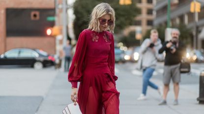 a woman with blonde hair walking down the street - scandi hairline