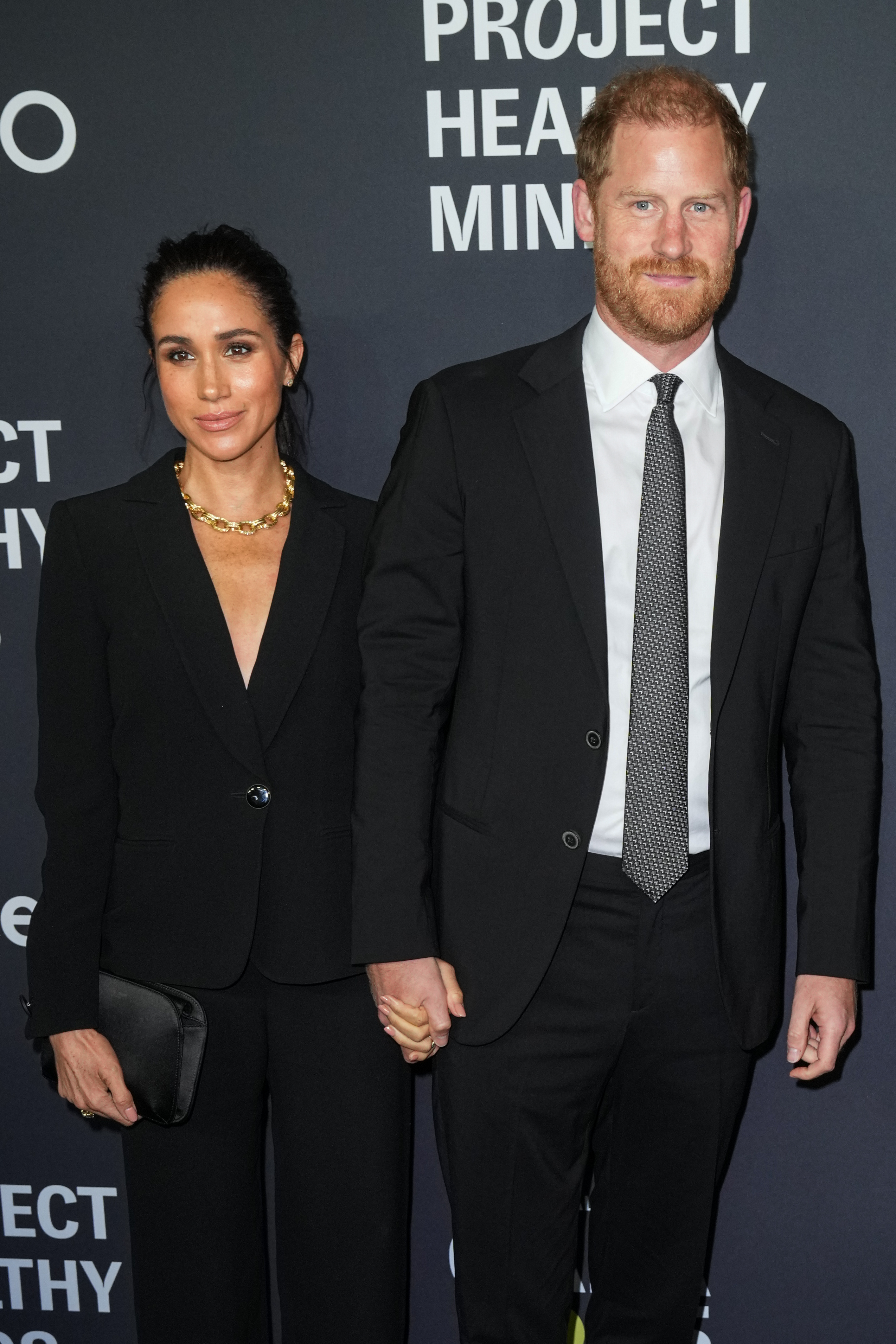 Meghan Markle and Prince Harry wearing black suits