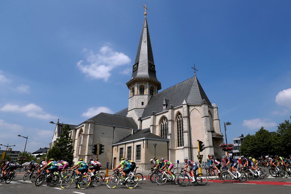 MAARKEDAL BELGIUM JUNE 09 Riccardo Stacchiotti of Italy and Team Vini Zabu Brado KTM Emils Liepins of Latvia and Team Trek Segafredo Oscar Riesebeek of Netherlands and Team AlpecinFenix The Peloton passing through Beveren City during the 90th Baloise Belgium Tour 2021 Stage 1 a 1753km stage from Beveren to Maarkedal Beveren SintMartinuskerk Church baloisebelgiumtour on June 09 2021 in Maarkedal Belgium Photo by Bas CzerwinskiGetty Images