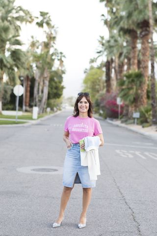 A former Nordstrom buyer wearing a knee-length denim skirt.