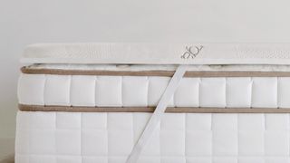 Saatva Mattress Topper review: image shows the topper attached to a luxury mattress via thick and elasticated anchor bands at each corner