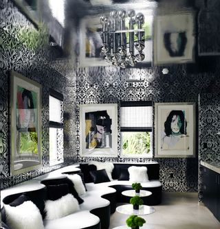 glamorous lounge in black and white, with chandelier and reflective ceiling