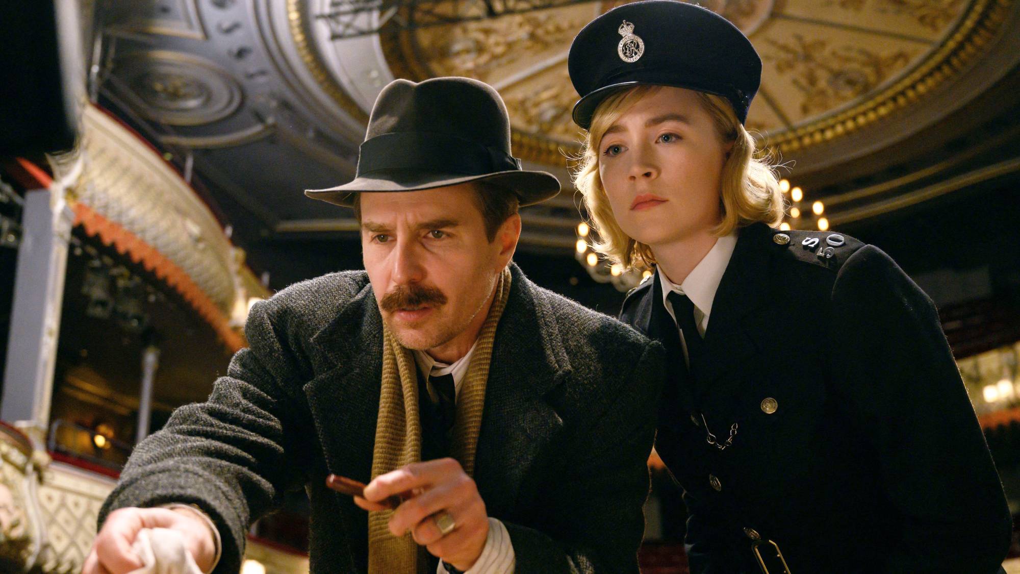 (L-R) Sam Rockwell as Inspector George Stoppard and Saoirse Ronan as Constable Stalker in "See How They Run"