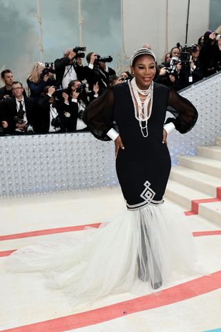 Serena Williams in a chic black gown with white detailing on the Met Gala red carpet 2023
