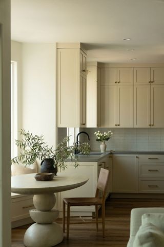 a neutral kitchen with off white cabinetry