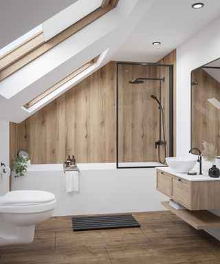 loft conversion bathroom with wood effect flooring, wall panelling, double velux roof light and bath with shower over