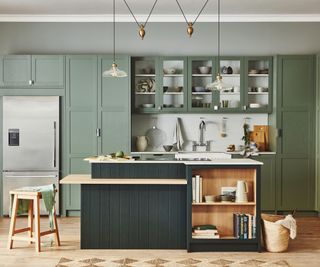 Two-tone kitchen cabinets with green wall cabinets and a dark blue island