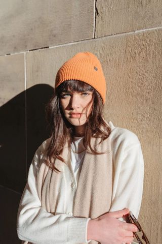 cold weather clothing - woman wearing orange beanie