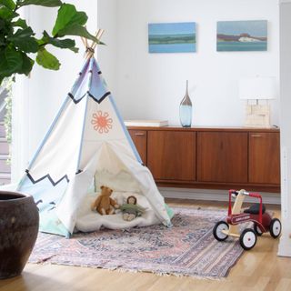 room with white wall and teepee
