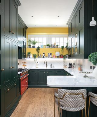 Dark green small kitchen dining area with bespoke built-in cabinetry