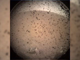 This photo is the first image of Mars taken by NASA's InSight Mars lander after its successful landing on the plains of Elysium Planitia on Nov. 26, 2018. The dust seen in the image is on a dust cover protecting the camera.