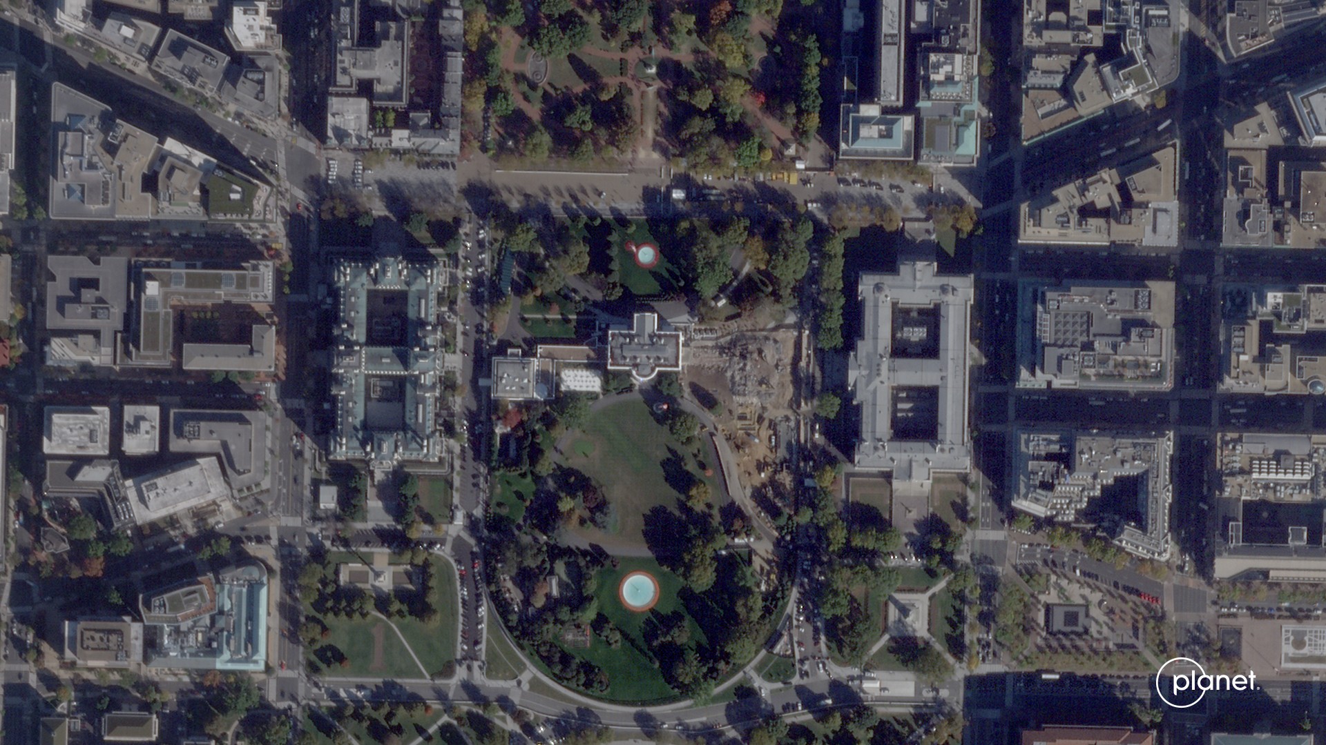 overhead images of a long rectangular building showing its eastern third being reduced to rubble