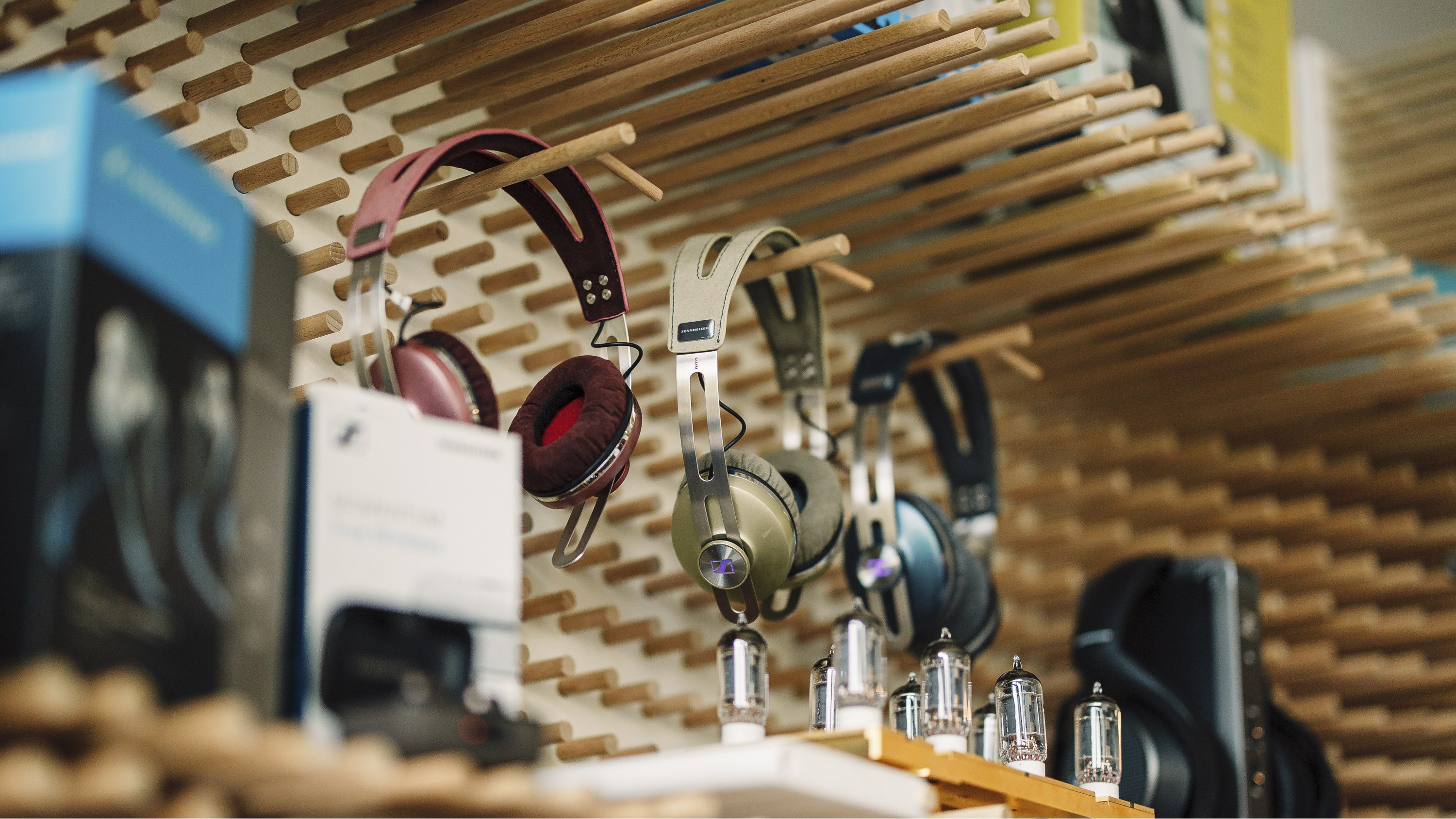 Sennheiser headphones hanging on a shelf