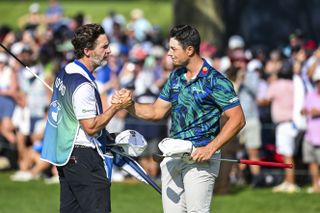 Viktor Hovland celebrates with his caddie after the BMW Championship at Olympia Fields