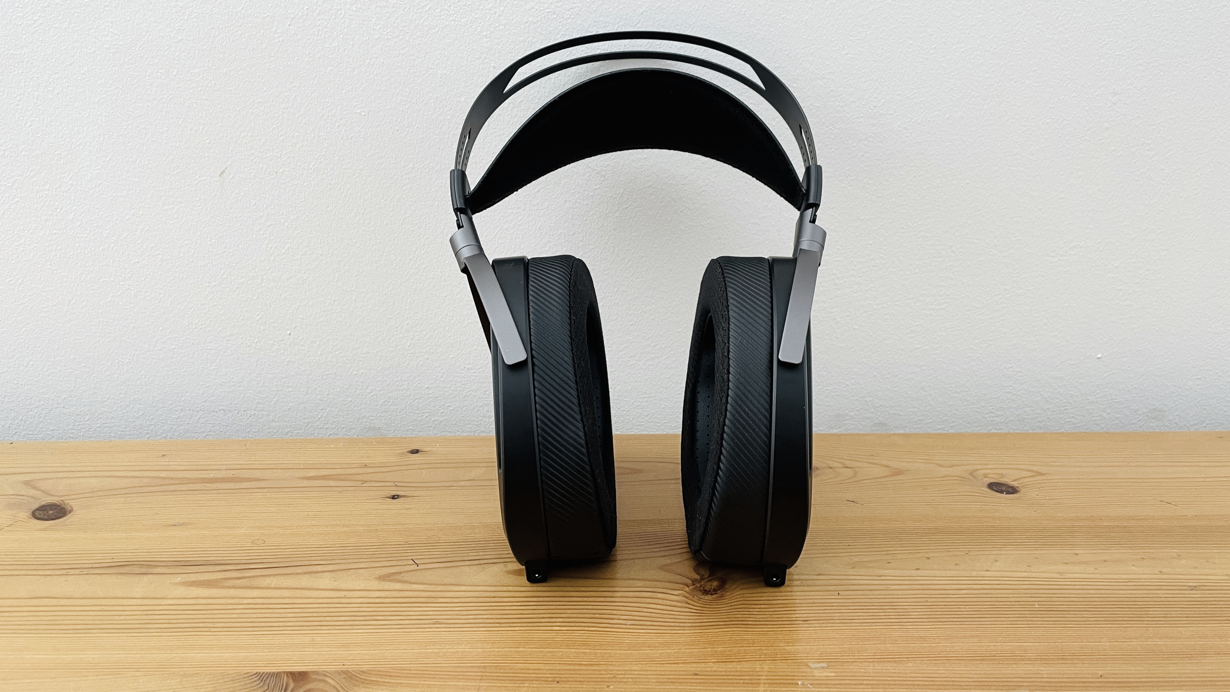 A picture of the Asus ROG Kithara audiophile wired gaming headset on a wooden surface.