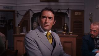 Gregory Peck in a striped suit and a tie in How The West Was Won