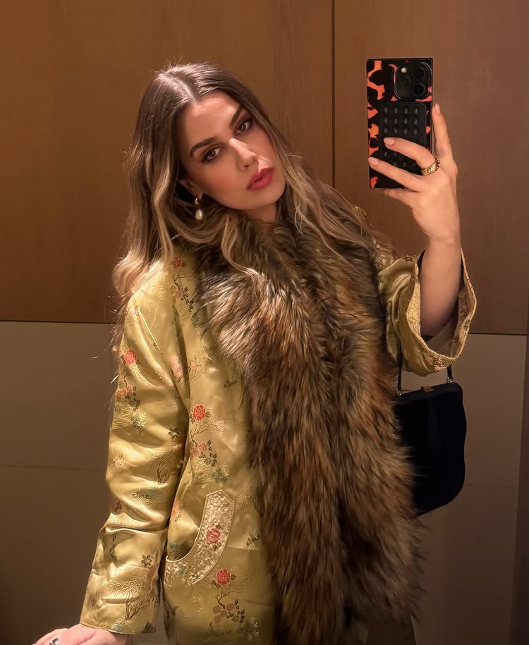 An image of @thepouf wearing an opera coat, one of the biggest spring jacket trends to wear with dresses.