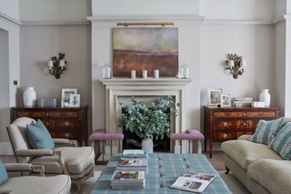 living room with fireplace and art over mantel