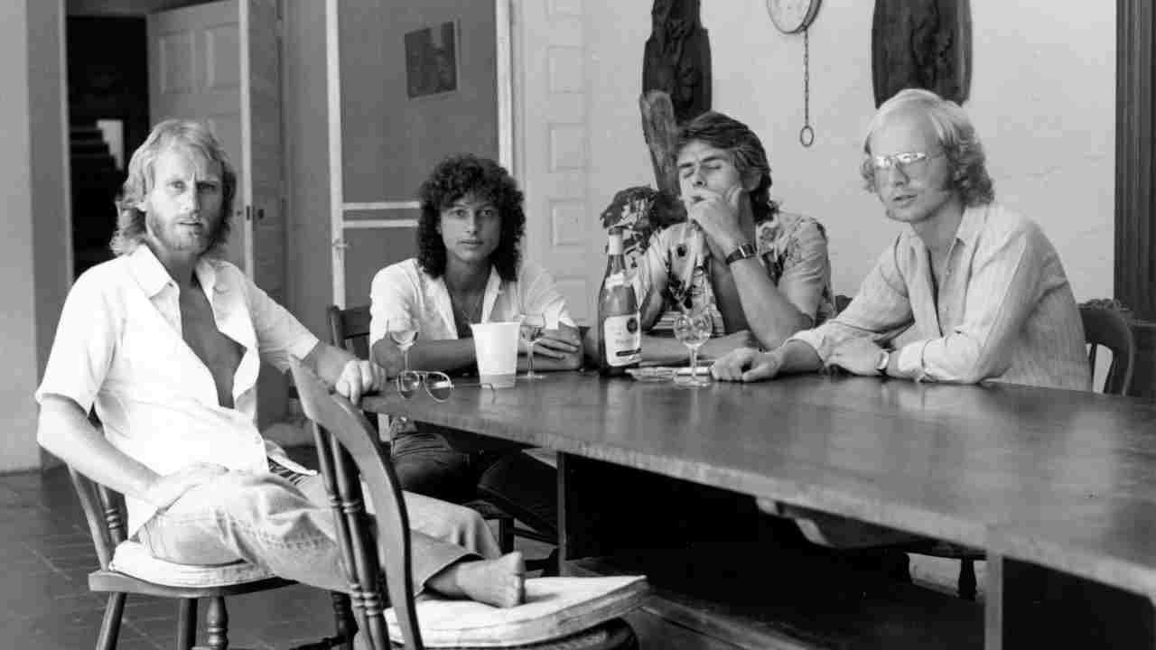 Wishbone Ash seated at a table in the 1970s
