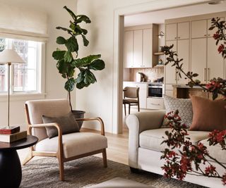 family room with neutral sofa and opening to kitchen