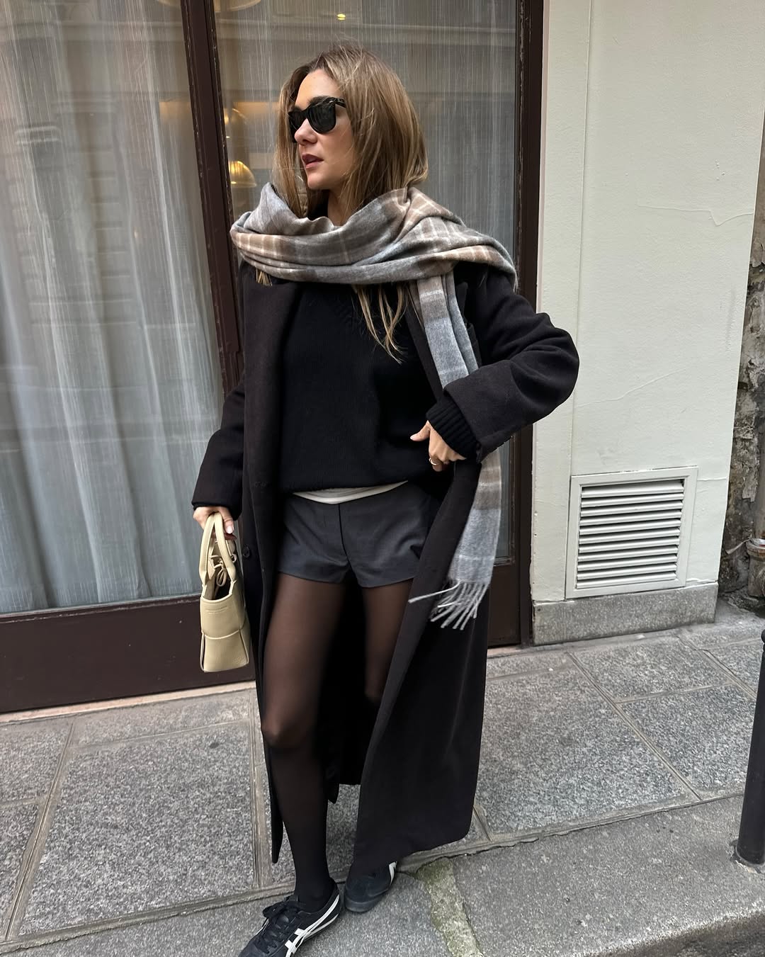 Woman wearing layering outfit idea 2026.