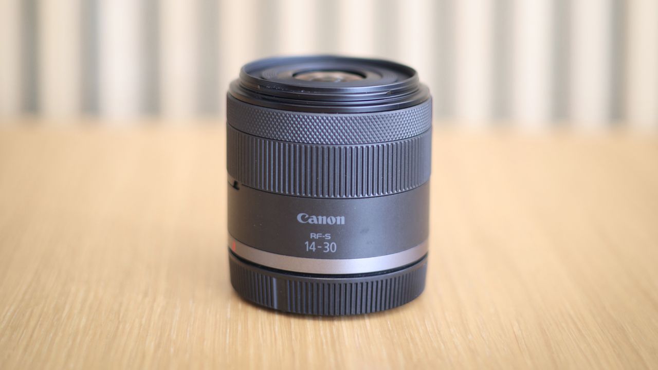 Canon RF 14-30mm f/4-6.3 STM PZ lens on a wooden surface