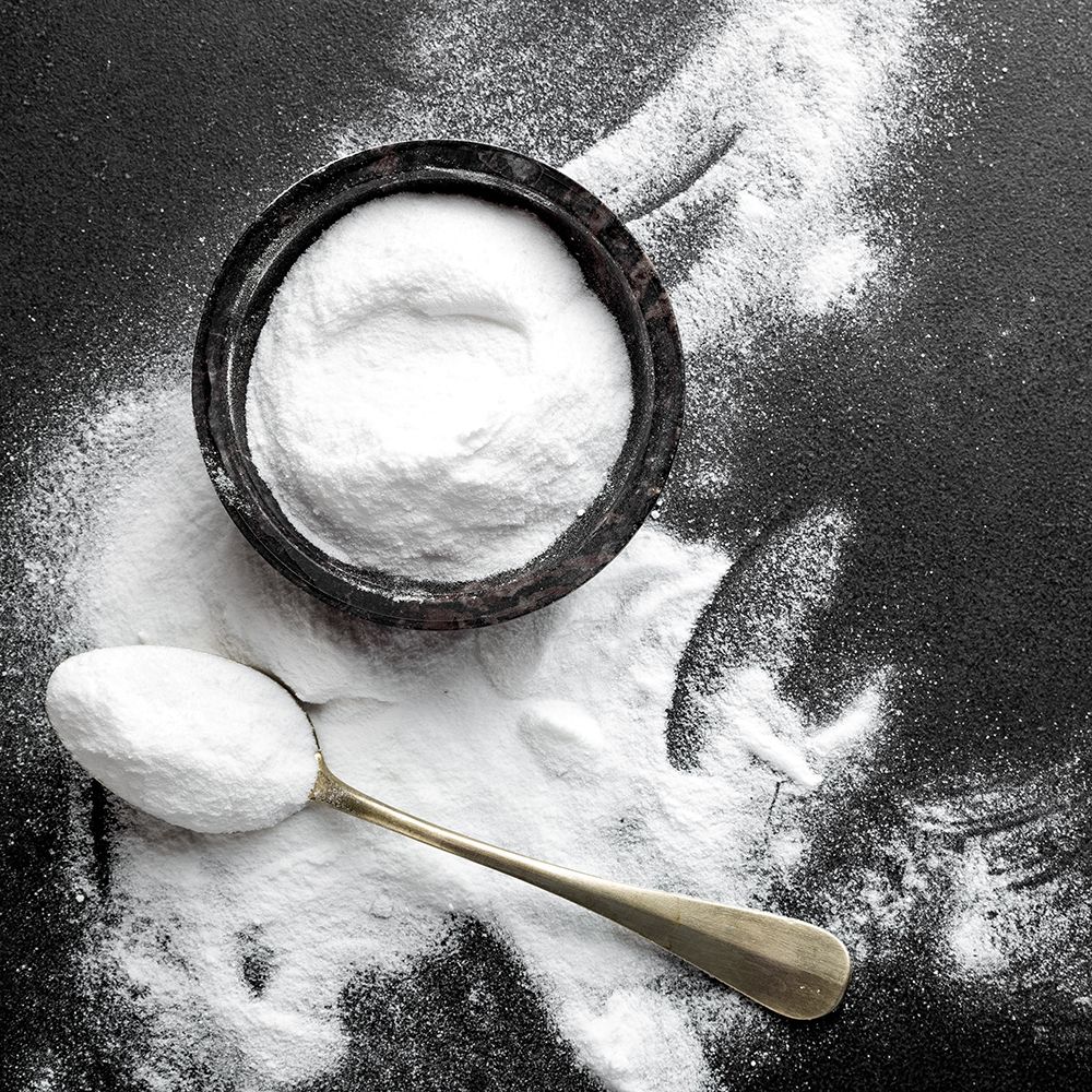 Spoon with backing powder and black background