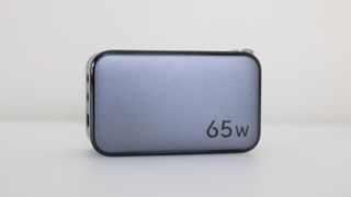 The front of the UGREEN Nexode 65W Charger with its 65 watt charging capacity clearly labeled