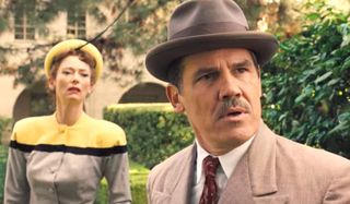 Tilda Swinton and Josh Brolin look shocked in a courtyard in Hail, Caesar.