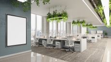 A modern, open plan office space with soft lighting and plants inside.