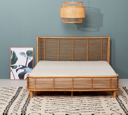 The Little Green Sheep mattress in bedroom on rattan bed