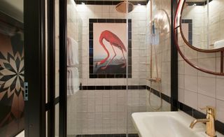 Black and white tiled bathroom with flamingo design on wall