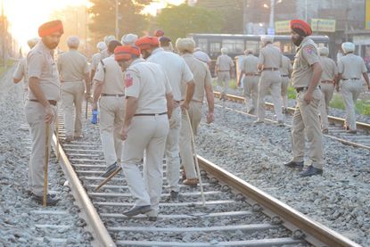 Police investigate the site of a deadly train accident in northern India