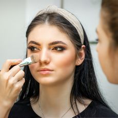 woman applying cream bronzer