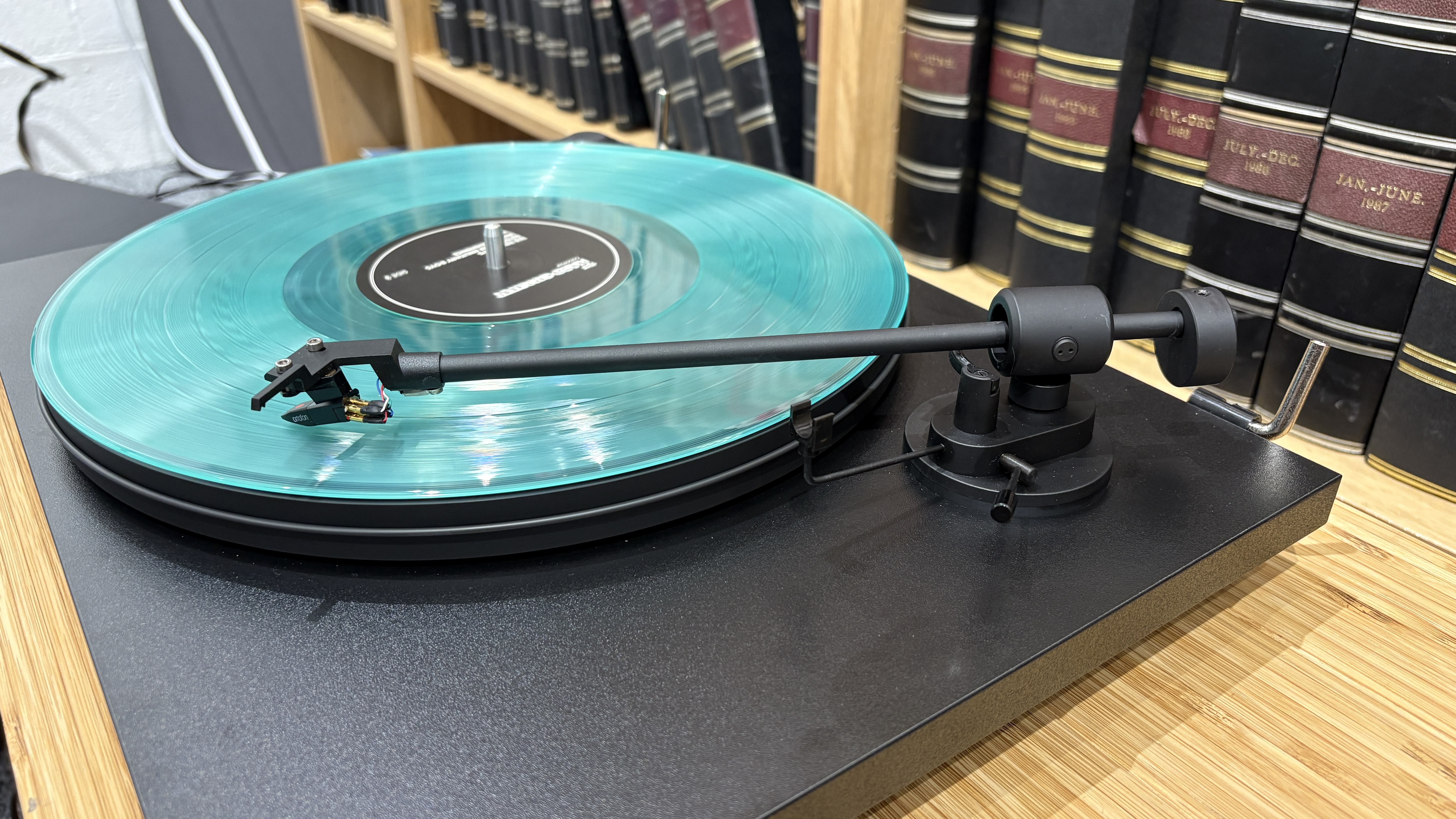 Pro-Ject Primary E turntable on wooden rack