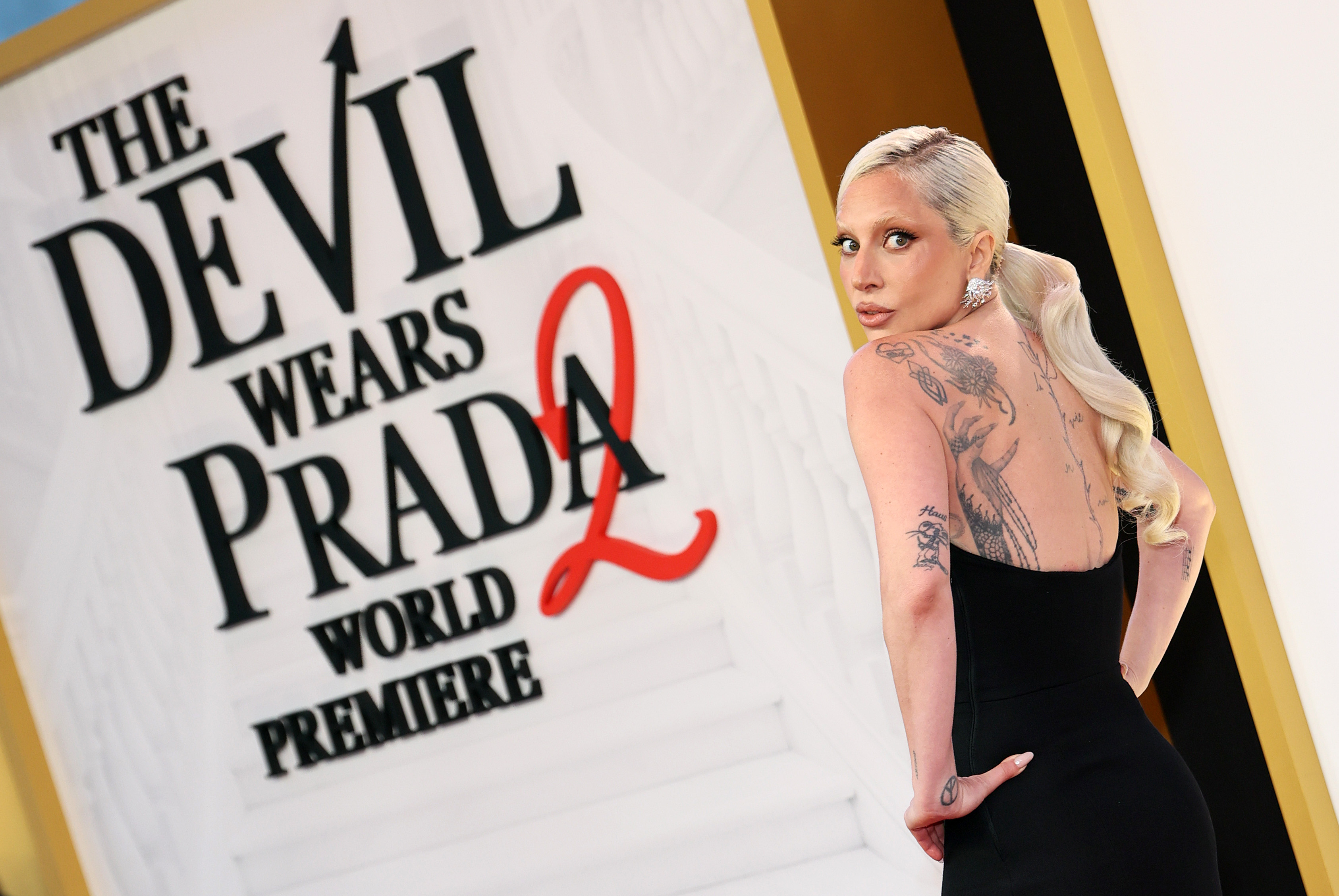 lady gaga poses on the red carpet at the new york premiere of the devil wears prada 2