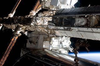 NASA astronauts Andrew Feustel (left) and Greg Chamitoff, both STS-134 mission specialists, participate in the Endeavour shuttle mission's first spacewalk outside the International Space Station on May 20, 2011. Here, the astronauts travel along the stat