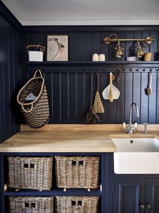 dark blue utility room with belfast sink and dark blue colour scheme