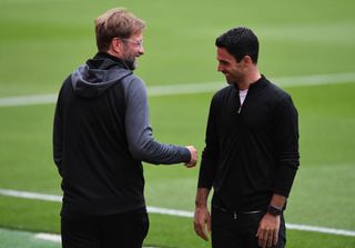 Arsenal and Liverpool managers respectively Mikel Arteta and Jurgen Klopp before the Premier League match between Arsenal FC and Liverpool FC at Emirates Stadium on July 15, 2020 in London, England. Football Stadiums around Europe remain empty due to the Coronavirus Pandemic as Government social distancing laws prohibit fans inside venues resulting in all fixtures being played behind closed doors.