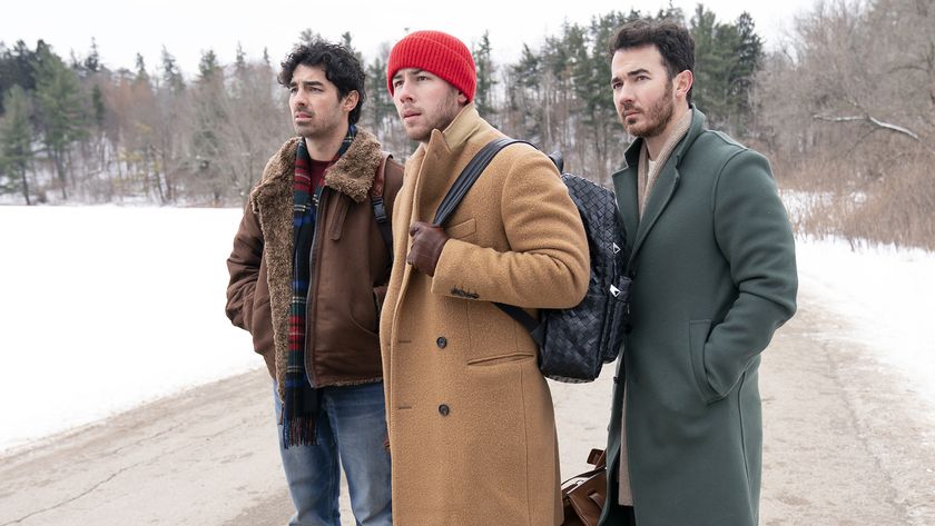 The Jonas brothers wearing winter clothes and standing in a snowy location in A Very Jonas Christmas Movie