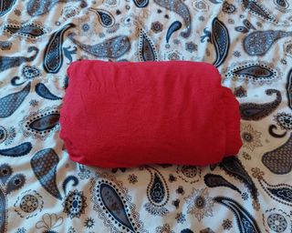 red fitted sheet being folded following a tiktok hack