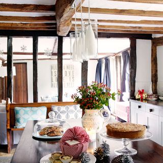 dining area with wooden beam and dining table with flower vase
