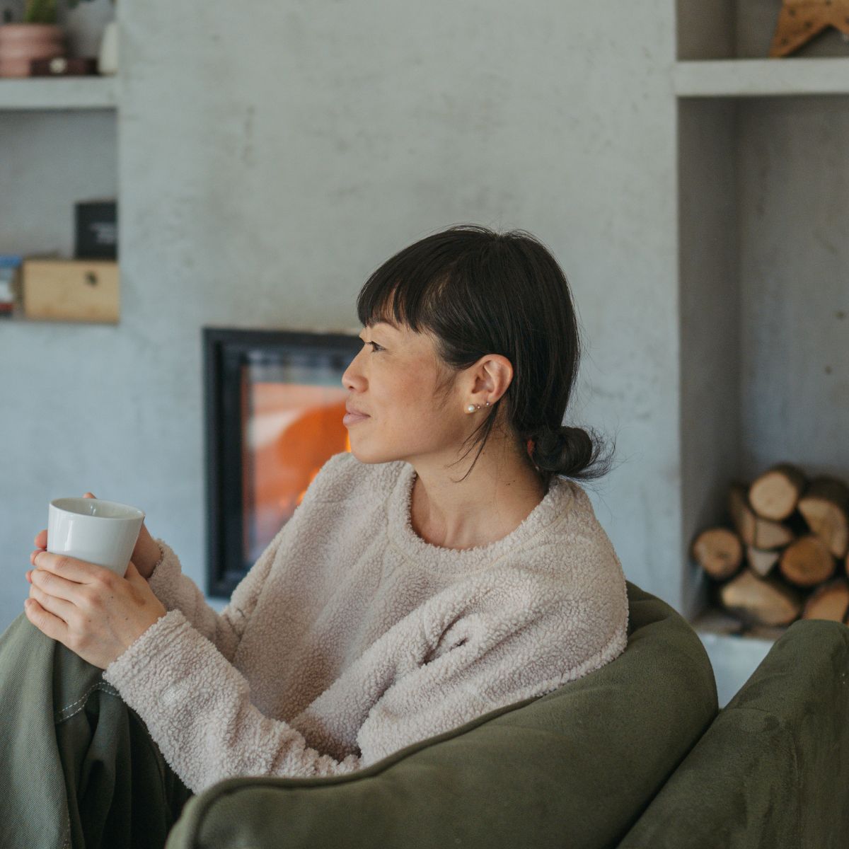 A woman practicing expert-approved autumn wellness rituals at home