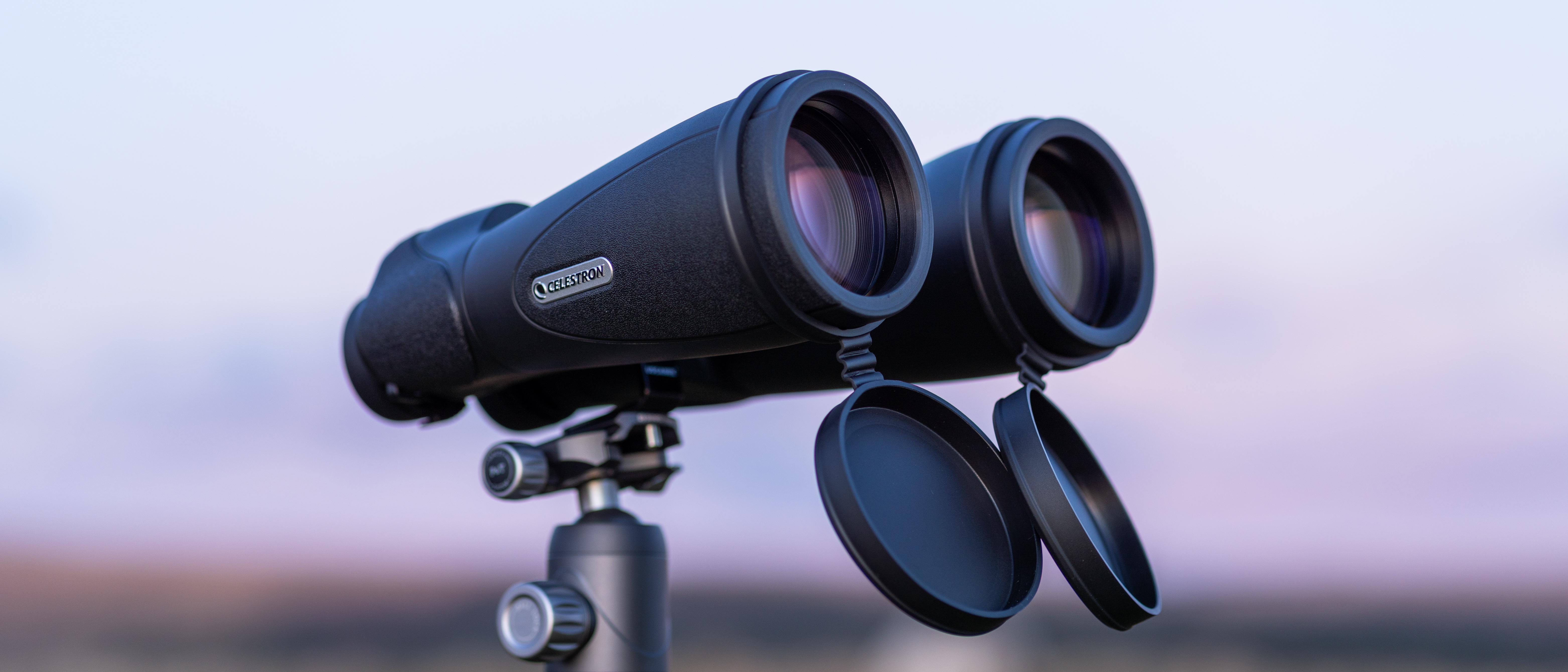 Celestron SkyMaster Pro ED 15x70 binoculars on a tripod at sunset