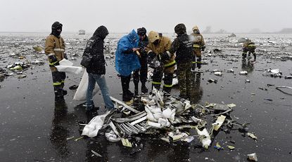 Investigators examine the wreckage from a fatal Flydubai crash