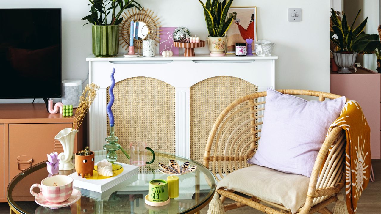 White painted living room with boho, natural theme, rattan armchair, coffee table, and TV unit