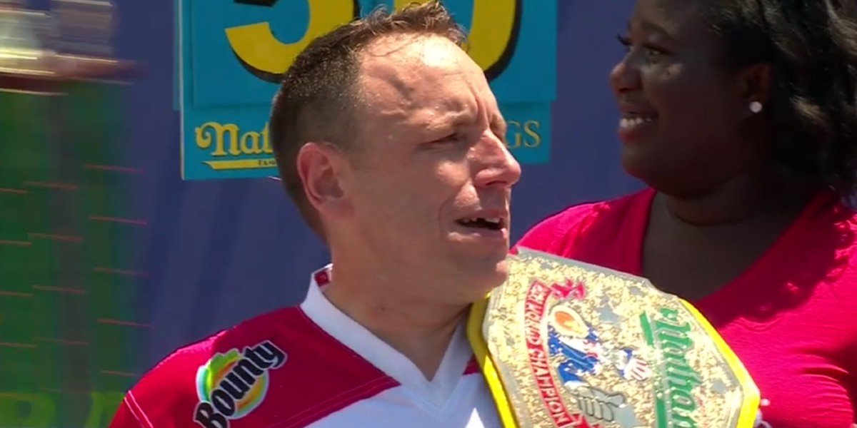 Joey Chestnut holding the Nathan&#039;s hot dog eating title ESPN