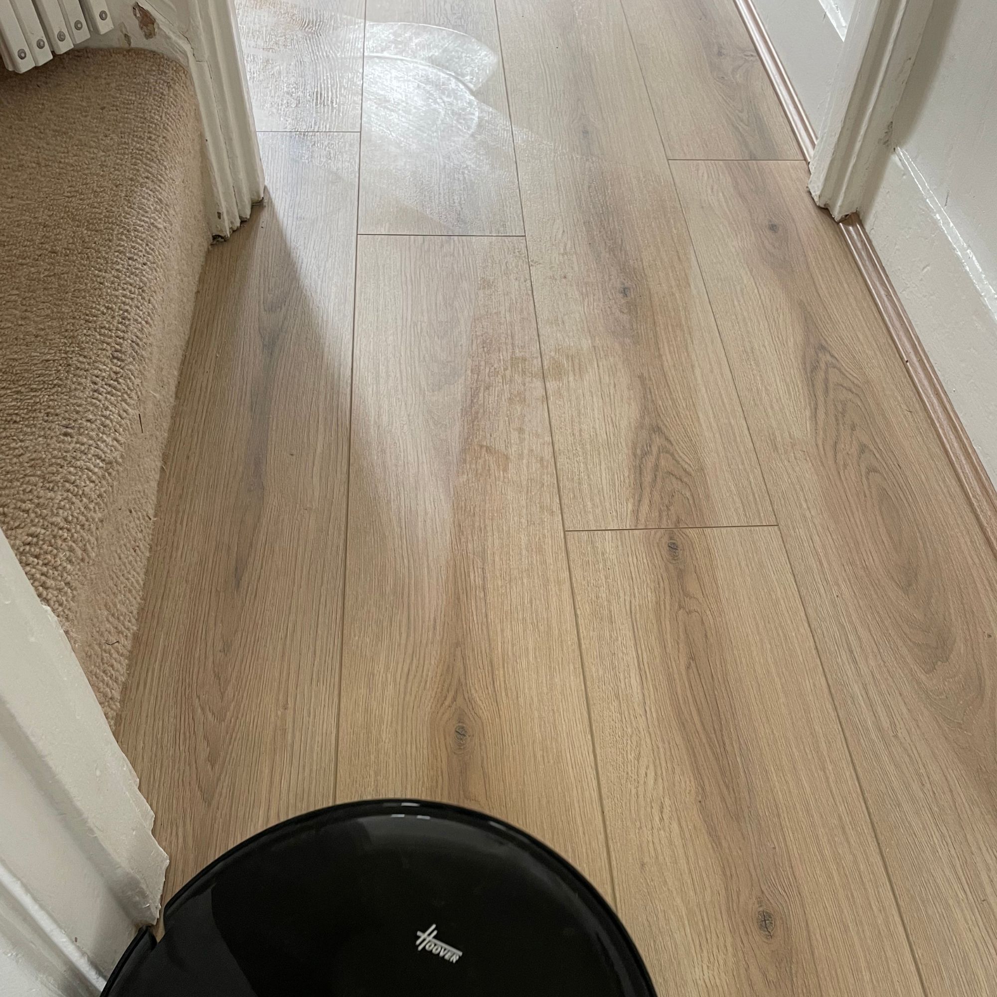 Hoover HG2 robot vacuum and mop with mop lines behind it